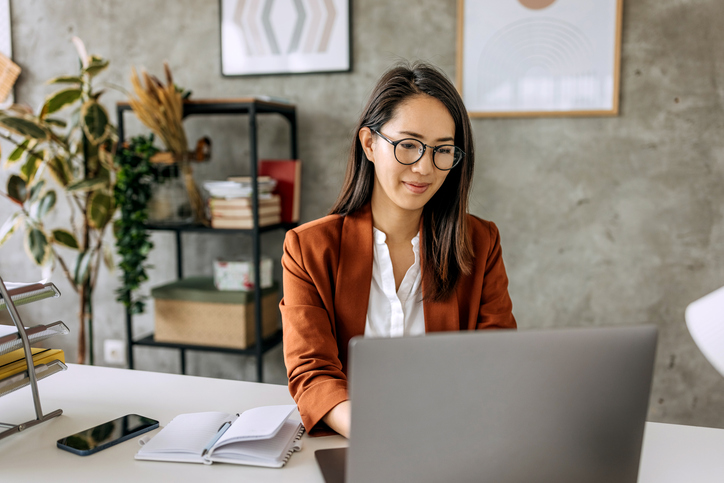 Well dressed beautiful mid adult businesswoman working from home office.