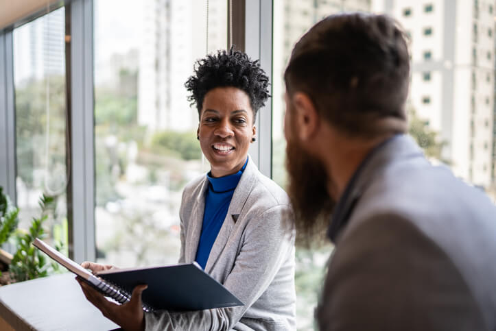 Two human resources professionals chatting informally after a meeting.