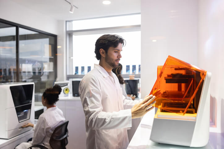 Team of health engineers bioprinting models at a 3D laboratory.