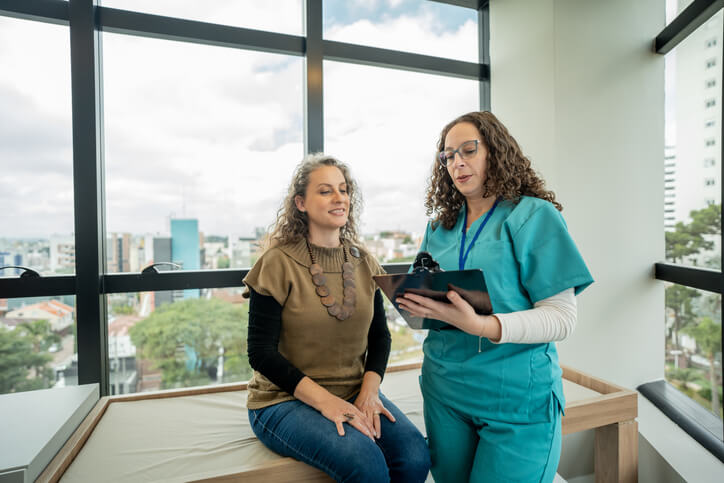 Mature woman in medical consultation with a female nurse practitioner.