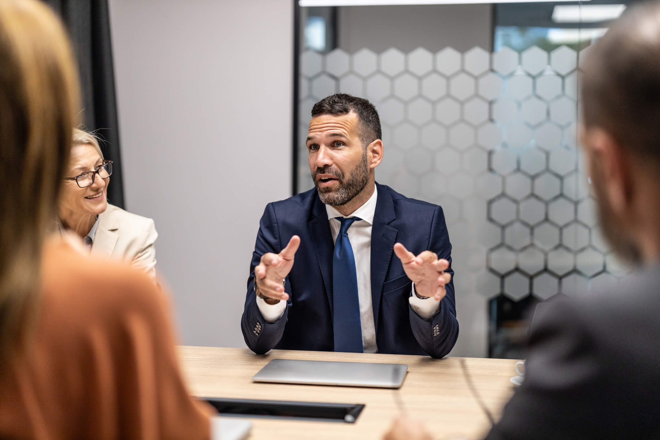 A dynamic business meeting captures engaged professionals discussing innovative ideas in a collaborative and modern corporate setting.